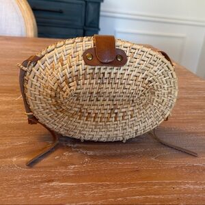 Round Woven Straw Crossbody Bag with Brown Accents